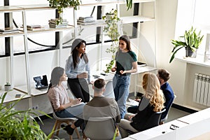 Concerned diverse office employees gather together solve business problems