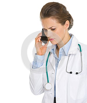 Concerned doctor woman speaking mobile phone