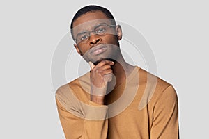 Concerned doubting african guy looking at camera studio shot