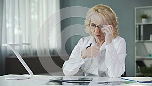 Concerned female pulmonologist examining X-ray of patient's lungs, diagnostics