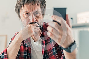 Concerned freelancer reading text message on mobile phone