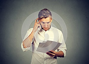 Concerned man reading paper documents