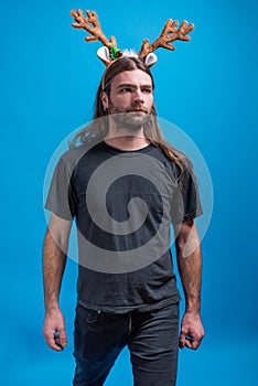 Concerned man wearing raindeer hair band looking away