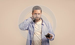 concerned moneyless man with wallet in studio. moneyless man with wallet at hand.