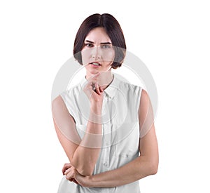 A concerned office lady isolated on a white background. Businesswoman in a thinking pose. A beautiful and strict young woman.