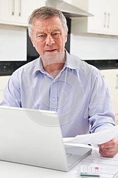 Concerned Senior Man Looking At Personal Finances