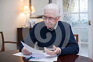 Concerned Senior Man Reviewing Domestic Finances