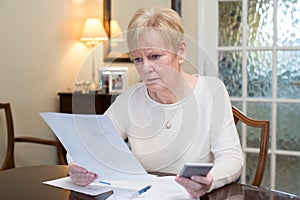 Concerned Senior Woman Reviewing Domestic Finances