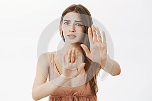 Concerned timid and insecure worried girlfriend begging friend to stop terrify her raising palms in defense or stop