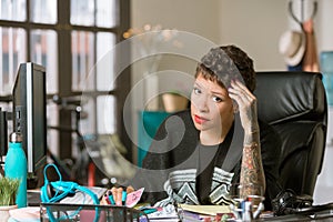 Concerned or Tired  Woman in a Creative Office