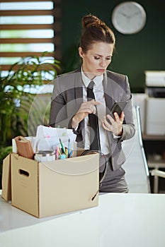 concerned woman employee in green office talking on phone