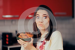 Concerned Woman Holding a Plate of Homemade Cabbage Rolls.