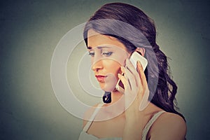 Concerned woman talking on mobile phone