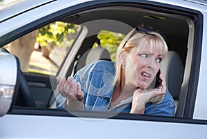 Concerned Woman Using Cell Phone While Driving
