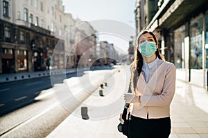 Concerned woman walking to work in public space during pandemic.Effect of the COVID-19.Protective measure,mask wearing.Respecting