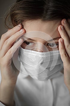 Concerned and worried woman medical worker in protective medical face mask. Doctor protection from Coronavirus, covid-19