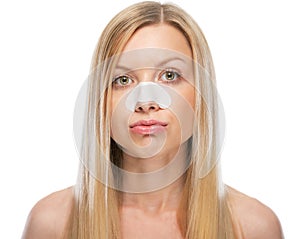 Concerned young woman with clear-up strips on nose