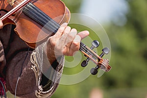 Concert of ancient music. Violin in the hands of a musician while playing the instrument_