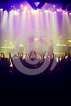 Concert, audience and stage with hands from fans at dj, band and festival event with lights and music. Rock show, dance