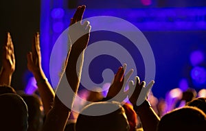 Concert crowd partying to the music performance on stage