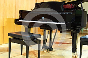 Concert grand piano and regulated bench in hall