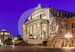 Concert Hall (Konzerthaus) and New Churchon Gendarmenmarkt square at night in Berlin, Germany
