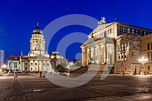 Concert Hall (Konzerthaus) and New Church on Gendarmenmarkt square at night in Berlin, Germany