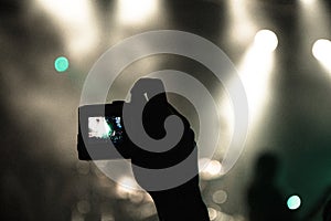 Concert hall with people clapping a band stage