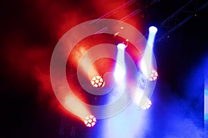 Concert lights, stage, show and excitement.  Light spots in concert, outdoor stage at night, foggy electricity.