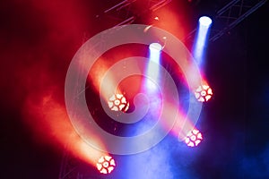 Concert lights, stage, show and excitement.  Light spots in concert, outdoor stage at night, foggy electricity.