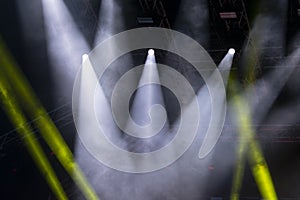 Concert lights, stage, show and excitement.  Light spots in concert, outdoor stage at night, foggy electricity.