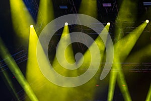 Concert lights, stage, show and excitement.  Light spots in concert, outdoor stage at night, foggy electricity.