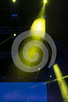 Concert lights, stage, show and excitement.  Light spots in concert, outdoor stage at night, foggy electricity.