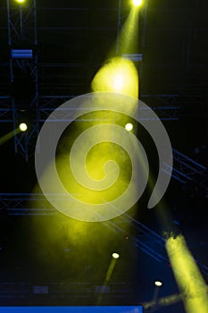 Concert lights, stage, show and excitement.  Light spots in concert, outdoor stage at night, foggy electricity.