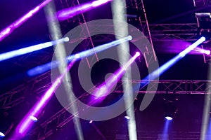 Concert lights, stage, show and excitement.  Light spots in concert, outdoor stage at night, foggy electricity.