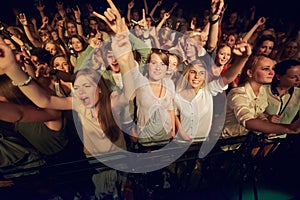 Concert, music festival and crowd with rock hands sign for singing, dance and night event, performance and celebration