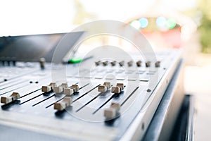 Concert in the Park. Sound mixer control, low angle shot with shallow depth field.