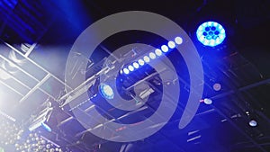Concert spotlights on stage. Laser beams in smoke