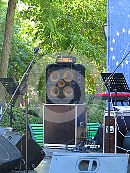 Concert stage: musical instruments, drums, amplifiers, speakers, microphones, cables photo
