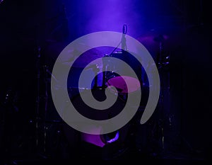 concert stage on rock festival, music instruments drum silhouettes, colorful background