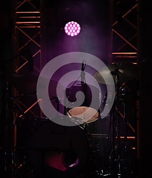 concert stage on rock festival, music instruments drum silhouettes, colorful background