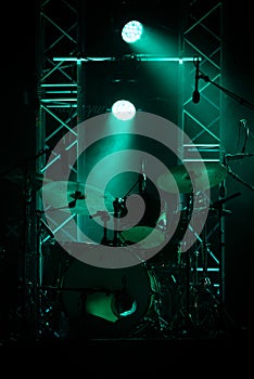 concert stage on rock festival, music instruments drum silhouettes, colorful background