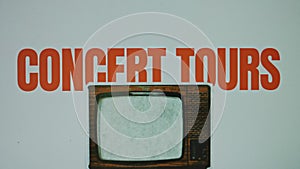 Concert tours inscription on grey background with image of a jumping vintage TV set, VHS effect on TV. Graphic