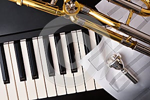 Concert for trombone and piano with instruments and sheet music