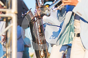 Concert view of saxophonist in a blue and white suit, a saxophone sax player with vocalist and musical band during jazz orchestra