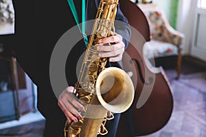 Concert view of saxophonist, saxophone sax player with vocalist and musical during jazz orchestra performing music on stage