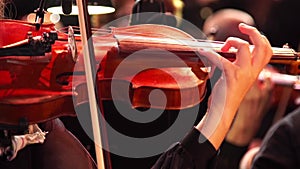 Concert, a woman playing the violin, hand close up