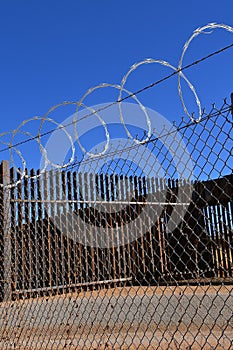 Concertina wire on top of barrier fences