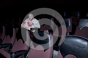 Man Enjoying Concessions in Movie Theater photo