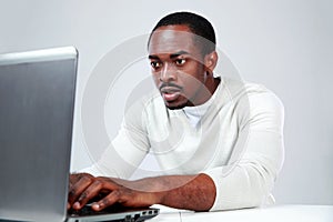 Concetrated african man using laptop